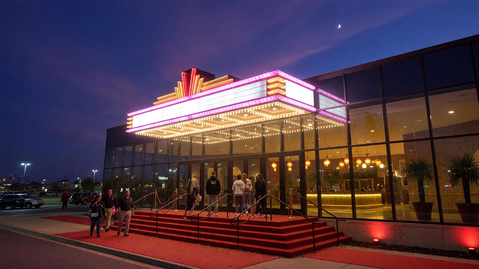 The Choctaw Grand Theater entrance at night with marquee lighting and a modern glass facade