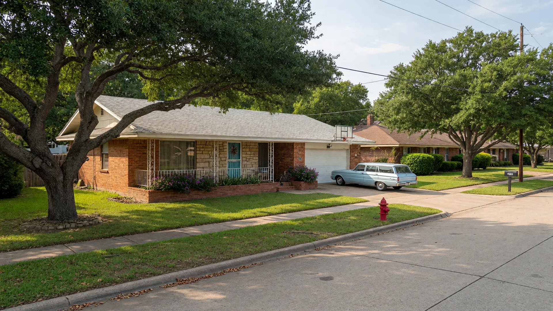 A single-story brick and stone mid-century ranch home on a tree-lined street in Windcrest, TX with mature live oaks and neat lawns, the kind of house a home inspector in Windcrest TX reviews
