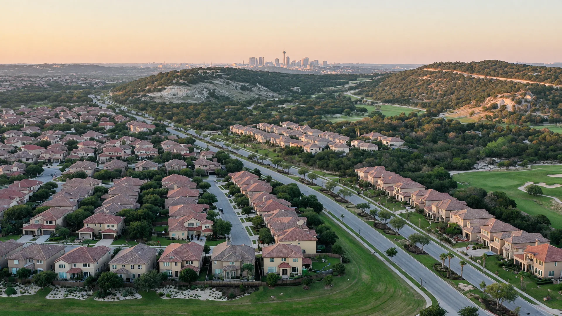 Aerial view of North San Antonio neighborhoods with red-tiled roofs and oak-lined streets