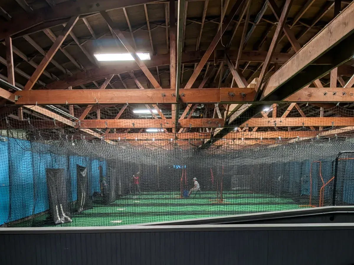 Wide multi-sport turf training area with line markings, cones, and agility ladders at Batter's Alley in Palmyra