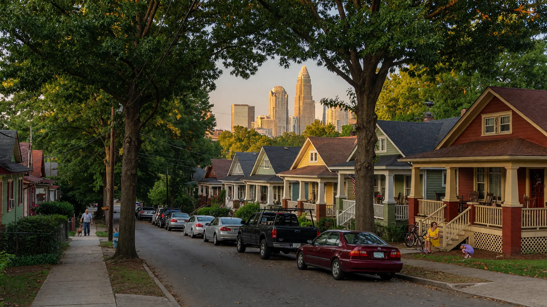 Tree-lined street in Cherry neighborhood Charlotte NC with historic Craftsman bungalows and early 1900s homes under warm afternoon light