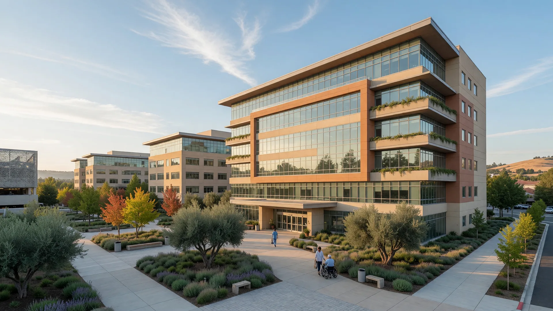 A modern medical center campus in suburban Northern California on a clear morning, with landscaped entry and warm architecture