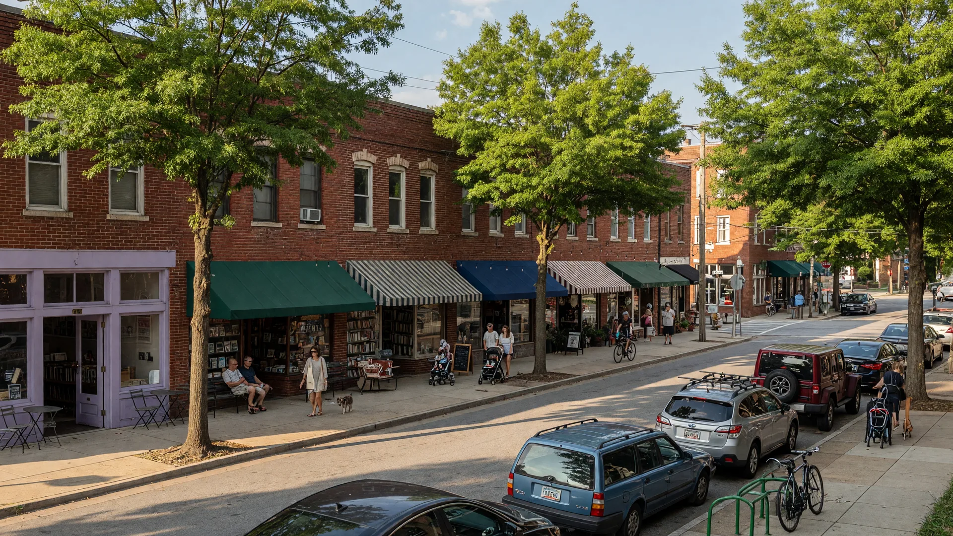 A walkable Virginia-Highland street with brick storefronts, shops and cafes under awnings