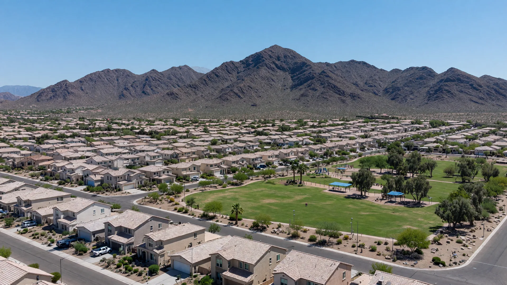Golden hour view of Goodyear, Arizona with the Sierra Estrella mountains and a master-planned community in the foreground