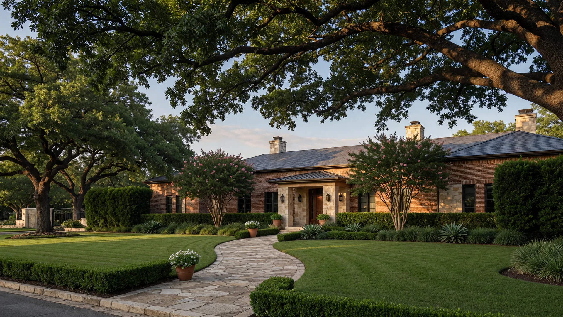 A large brick and limestone custom estate home in Hill Country Village, TX set back on a manicured lot under mature live oaks, the kind of house a home inspector in Hill Country Village TX reviews