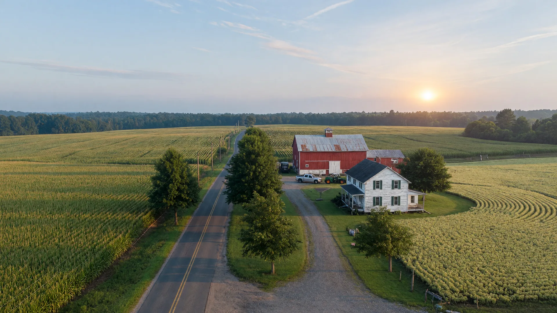 Rolling farmland and a quiet gravel drive leading to a white farmhouse with a red barn in New Hanover Township, Burlington County