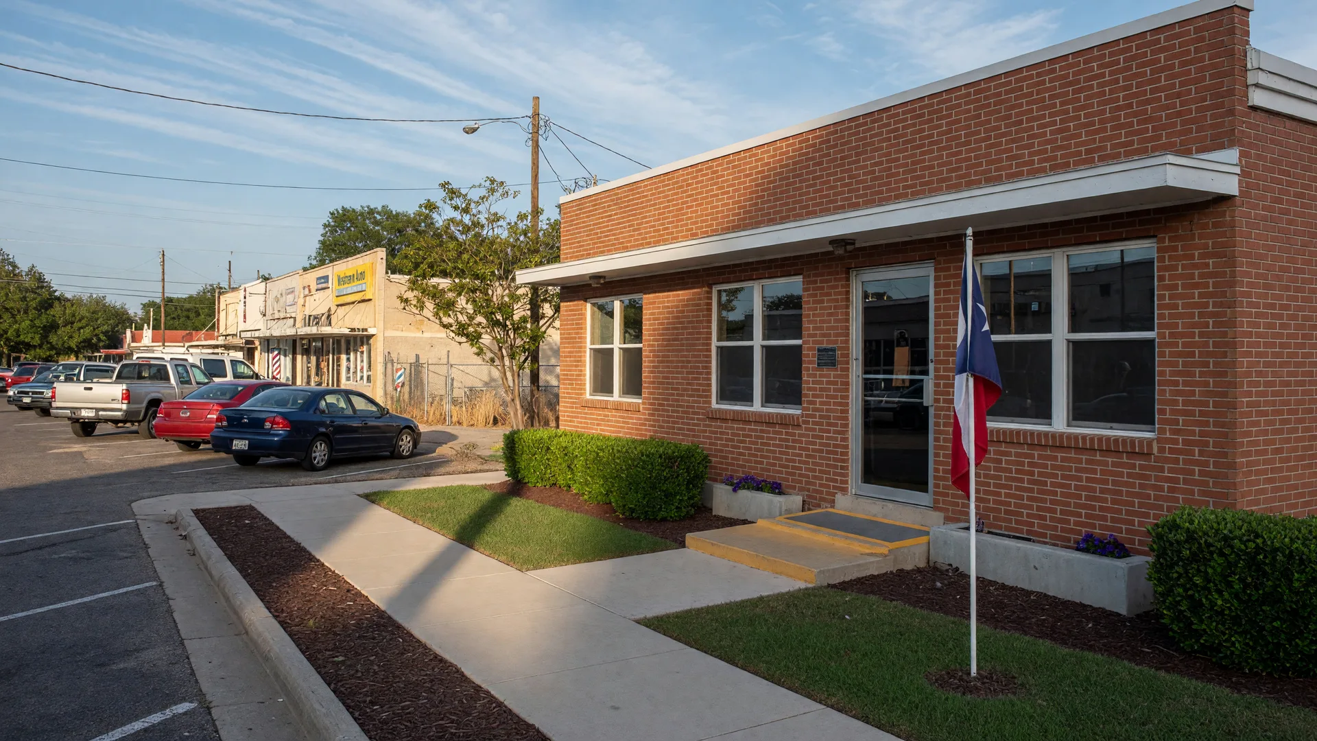 Freshly remodeled brick community resource center building on a small-town Texas commercial street