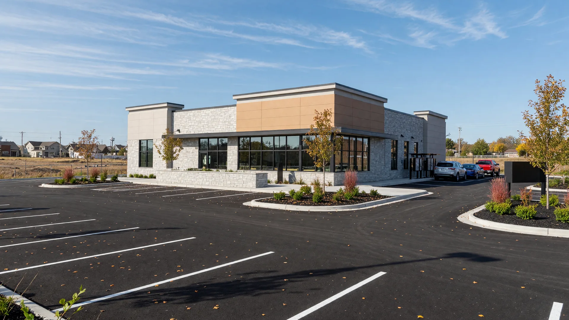 A newly built fast-casual restaurant with a drive-thru lane in a growing Minnesota town on a bright autumn day