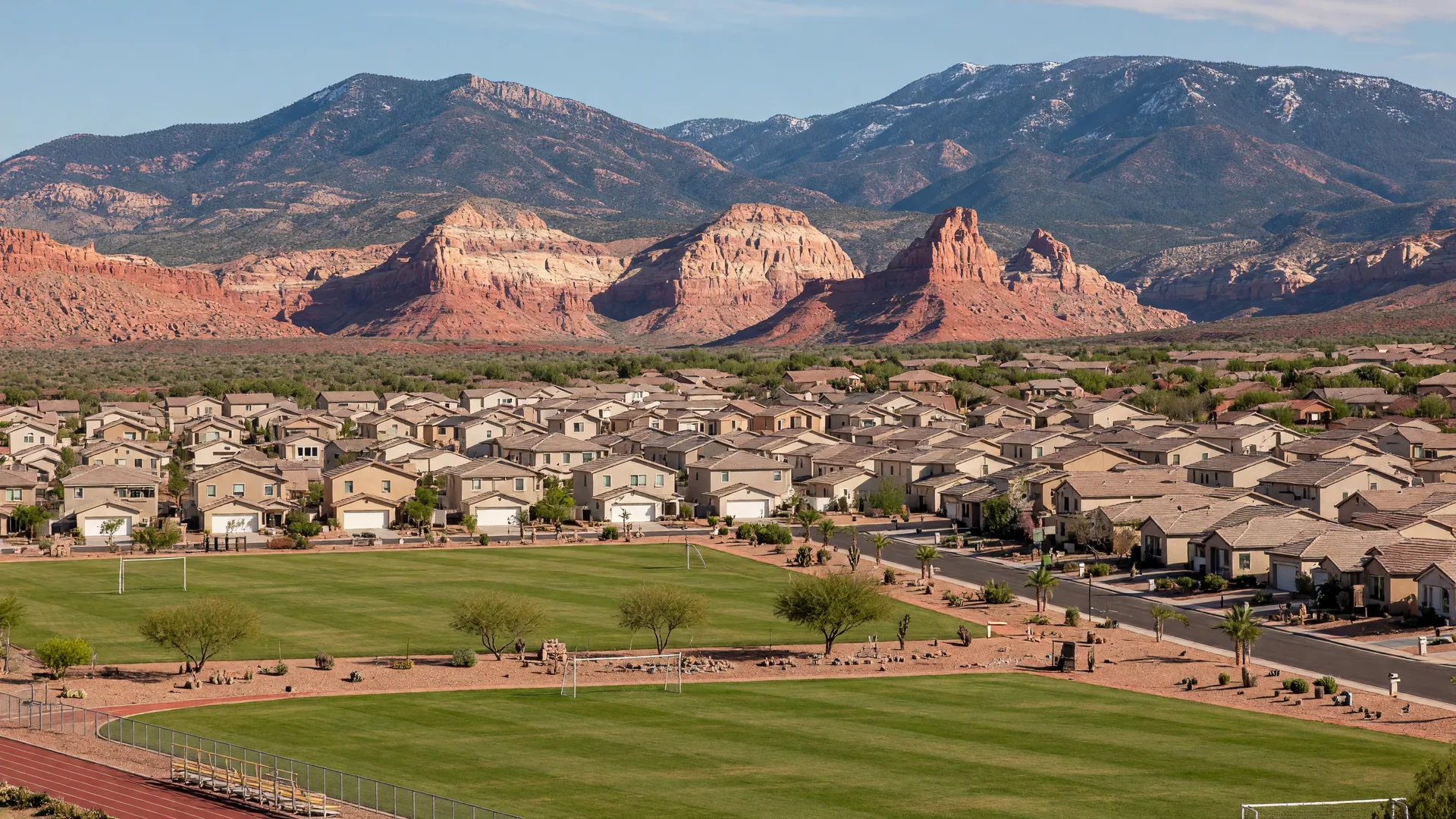 AI-rendered concept image of the Little Valley master-planned neighborhood in St. George with green sports fields and red rock mesas