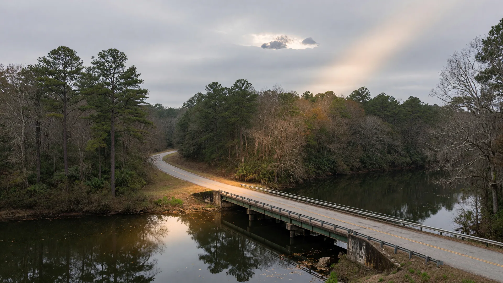 Country road crossing a small bridge over the Ocmulgee River in rural Twiggs County, Georgia