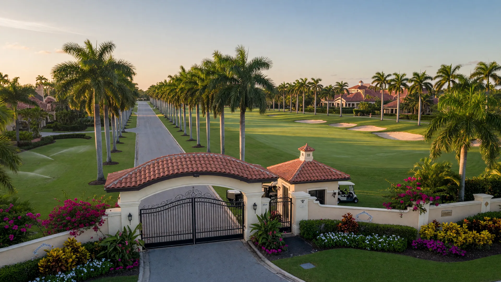 Mediterranean-style entrance gate to Woodfield Country Club in Boca Raton with palm-lined boulevard and tropical landscaping