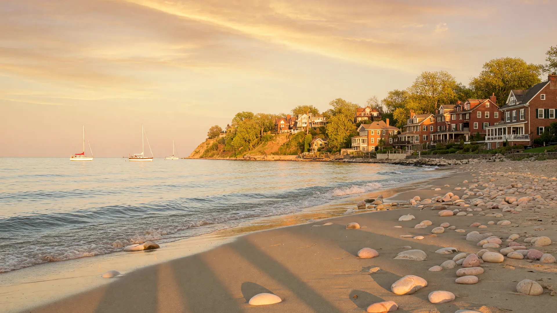 Lake Erie shoreline at golden hour with a bluff-top neighborhood