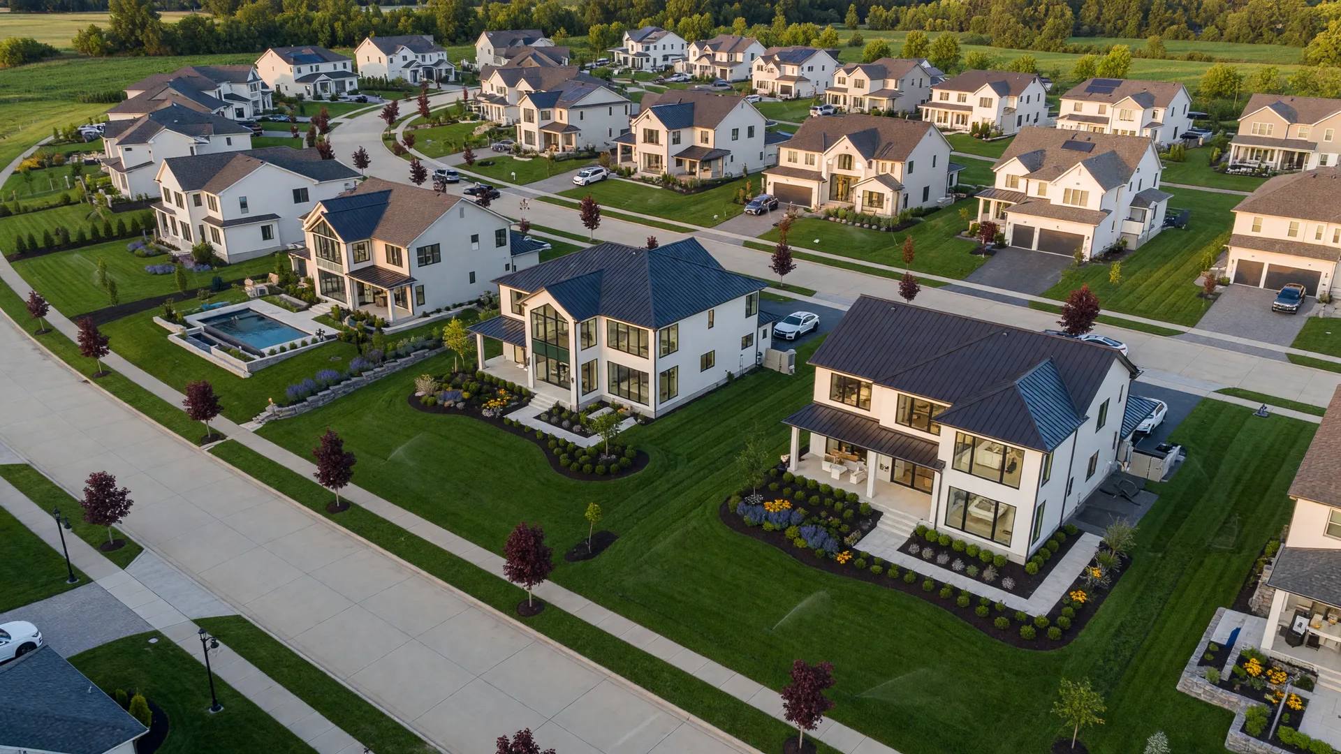 Newell Creek subdivision in Mentor, Ohio featuring upscale modern homes with professional landscaping at golden hour