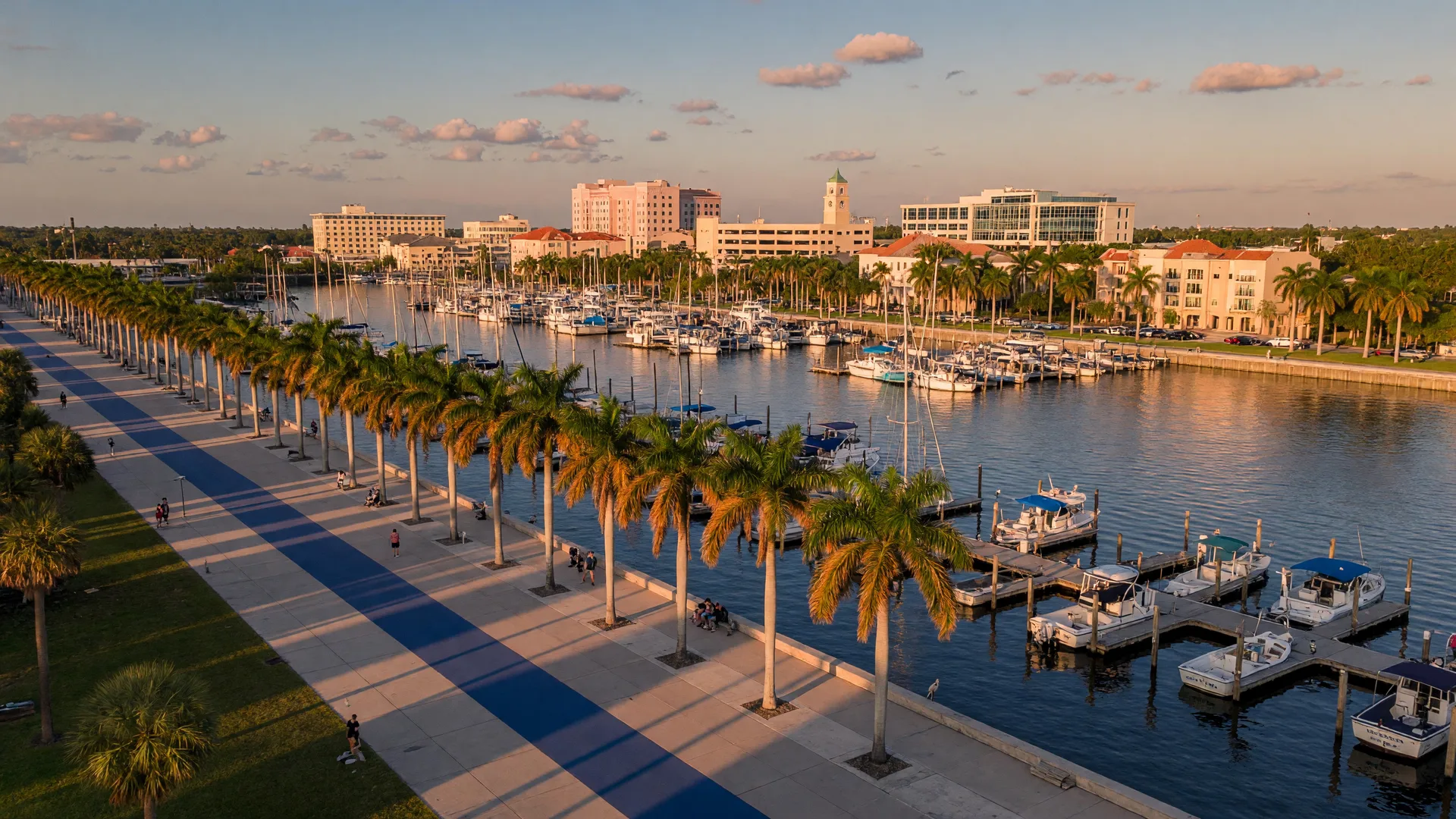 Aerial of Bradenton's Riverwalk along the Manatee River with a marina and the downtown skyline