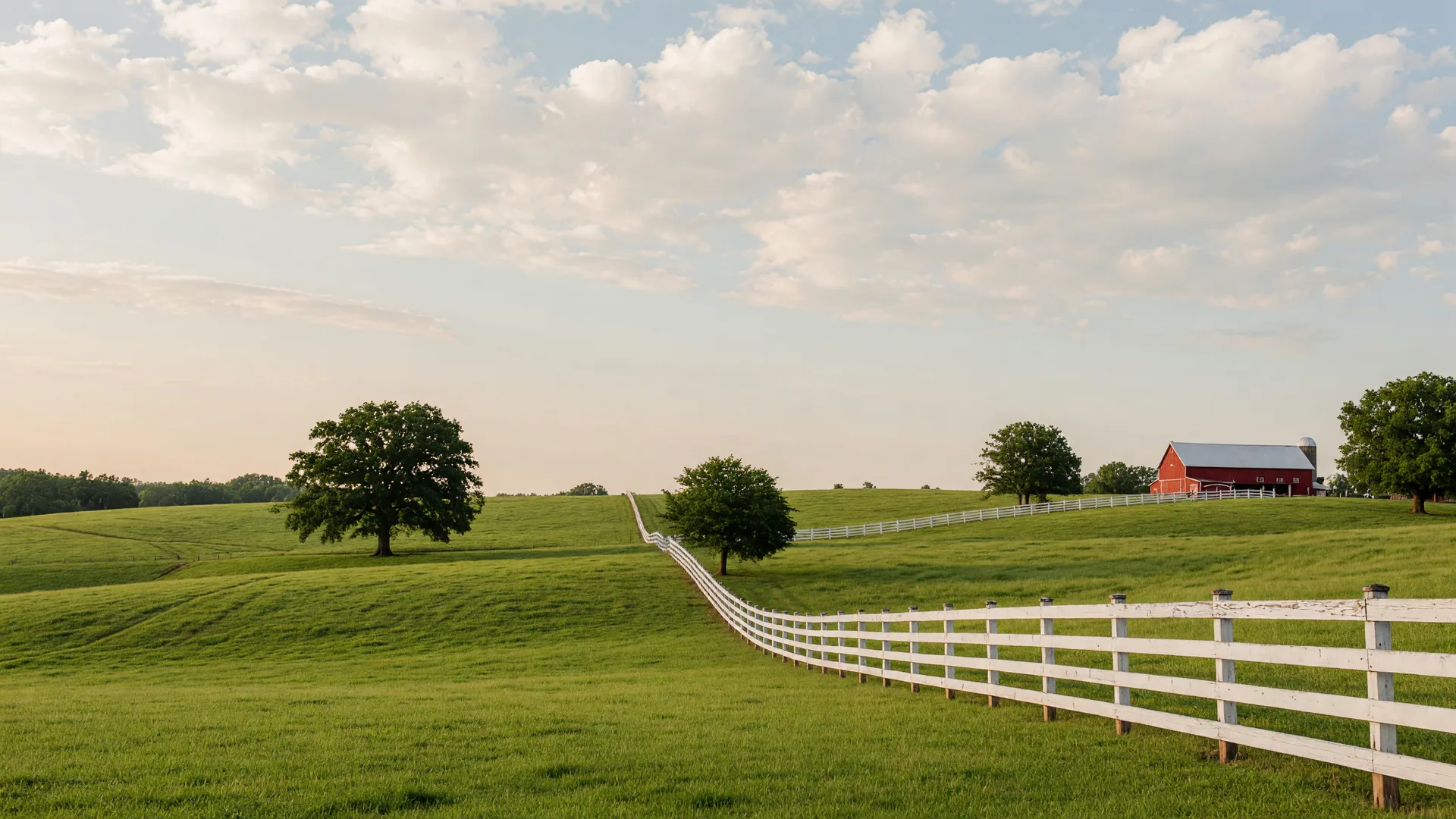 Rolling green pastures with white horse fencing in northeast Georgia
