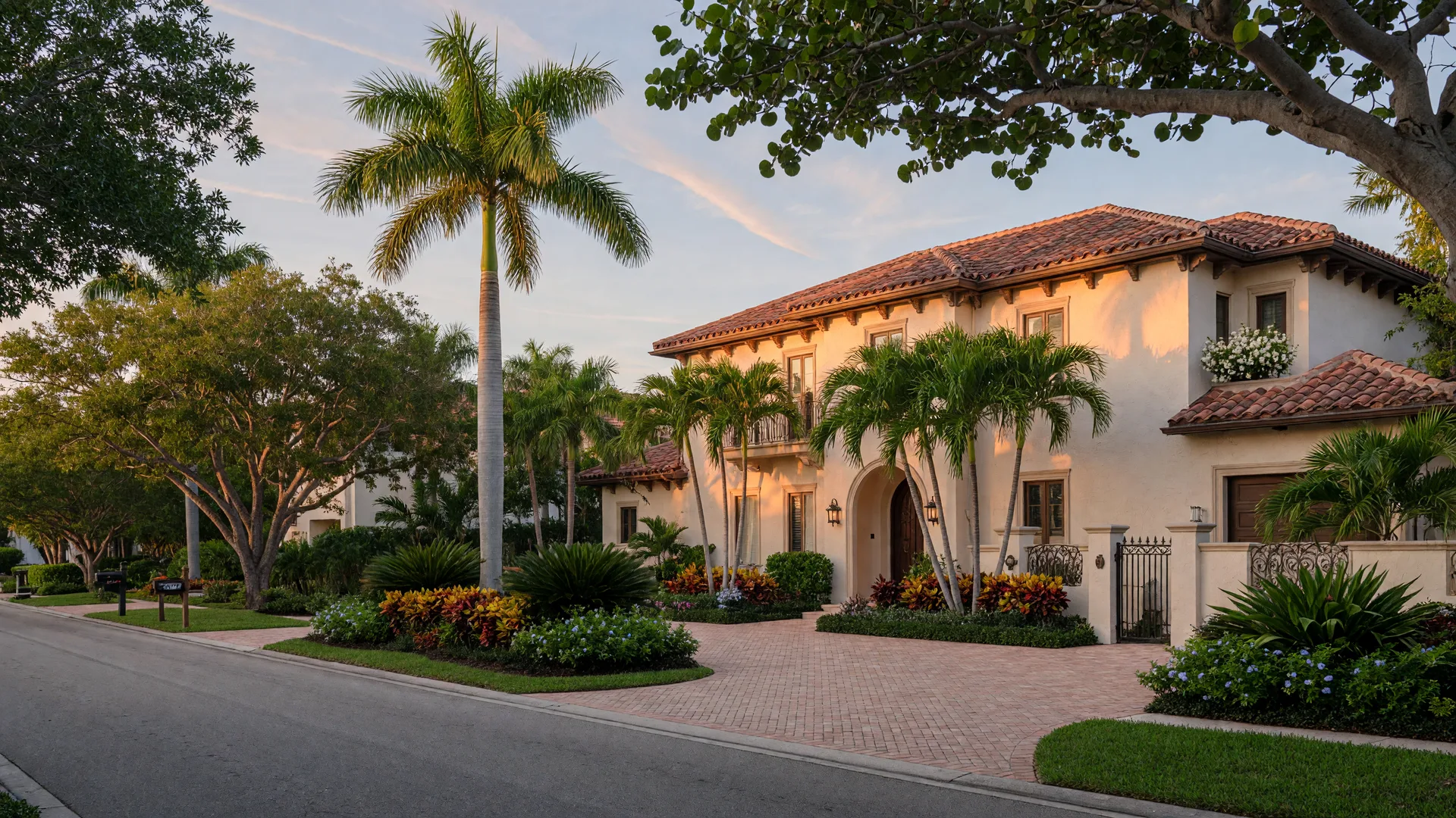 Elegant Mediterranean-style luxury home on a quiet residential street in Naples, Florida at late afternoon