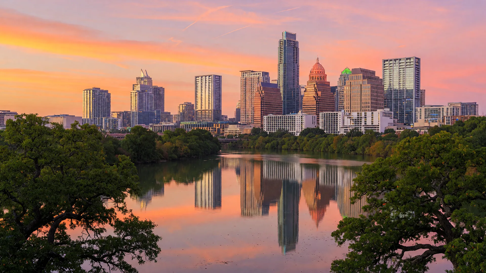 Austin Texas skyline at golden hour reflecting in the Colorado River