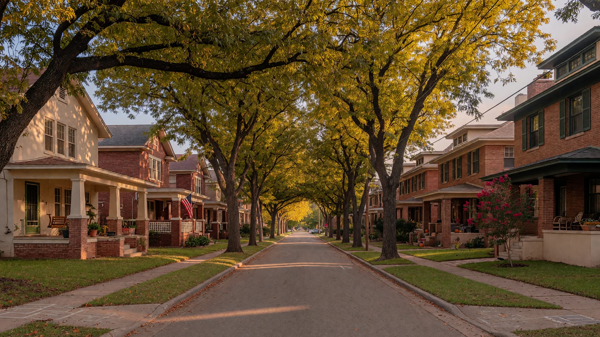 A tree-lined street in Vickery Place, East Dallas, with 1920s Craftsman bungalows and new brick townhomes under mature pecan trees