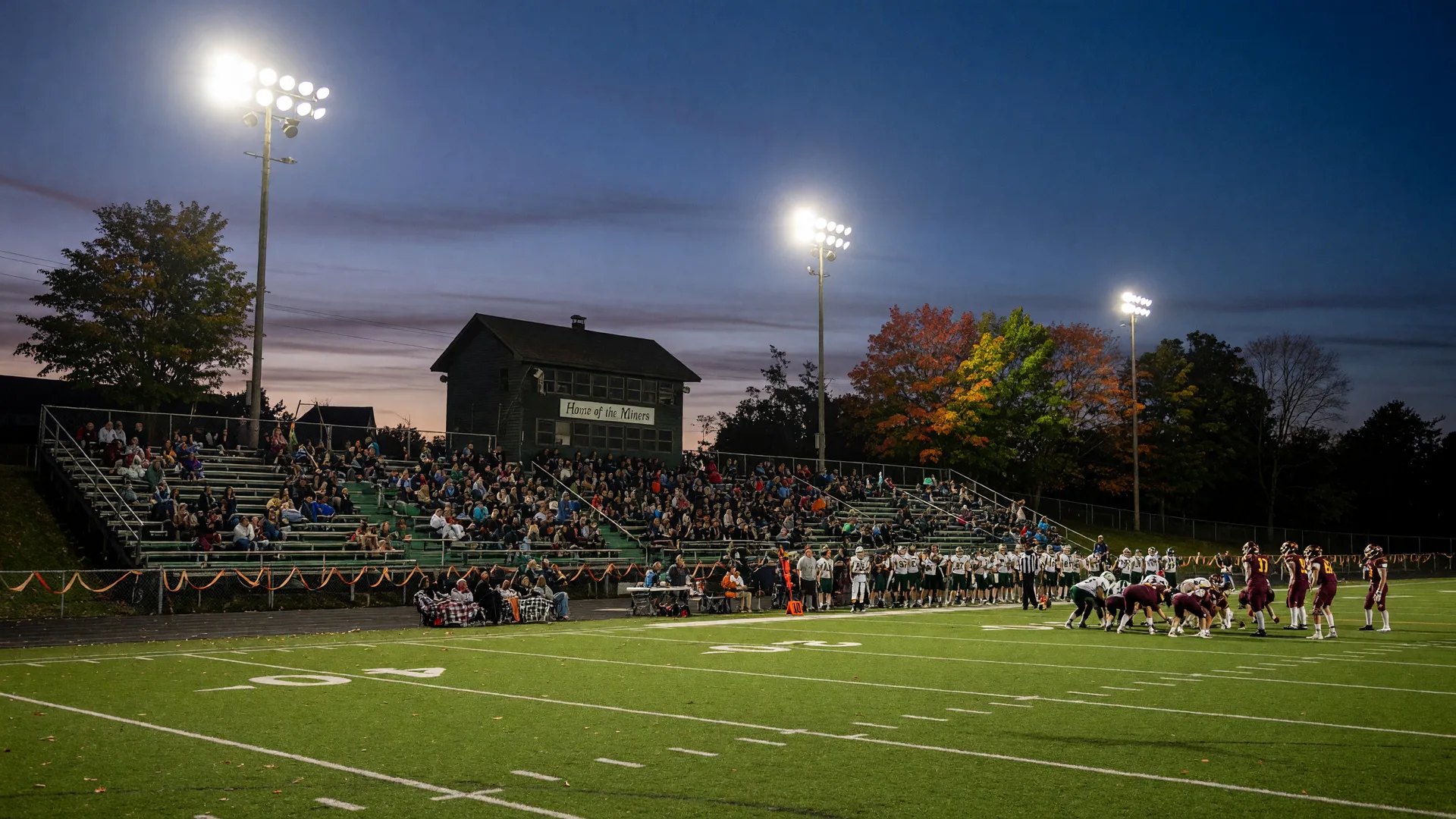 Friday-night high school football under stadium lights in a small Pennsylvania borough in September