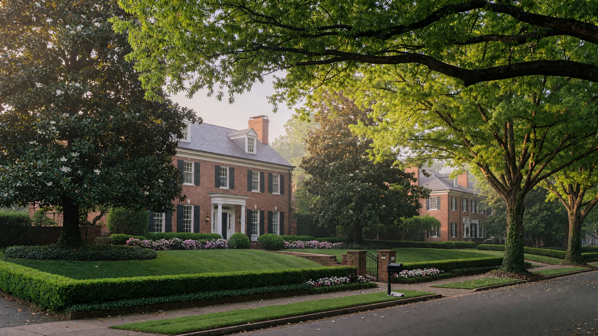 Stately brick homes on a magnolia-lined street in Myers Park Charlotte beneath a canopy of mature trees