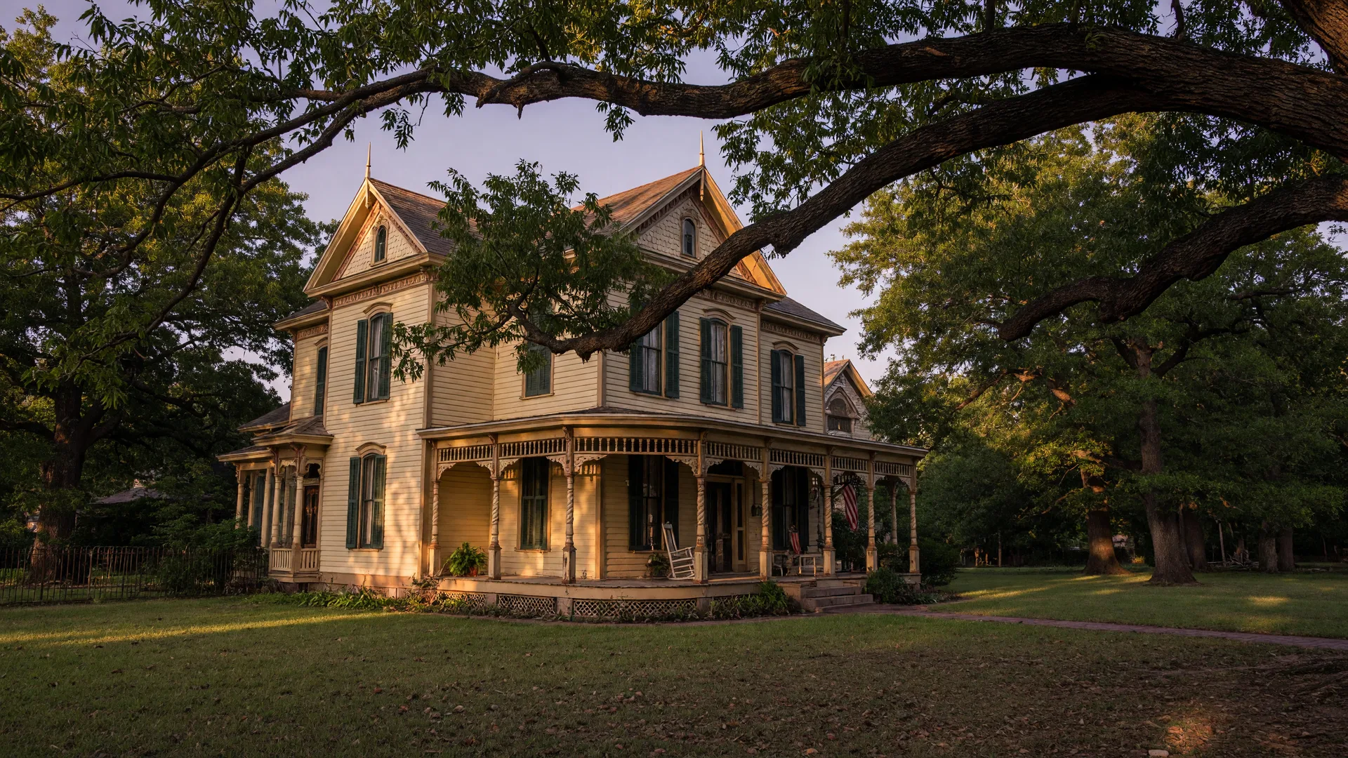 A historic 19th-century Victorian home under giant pecan trees in Seguin, Texas at late afternoon, in the home inspection service area of Rodeo Home Inspections