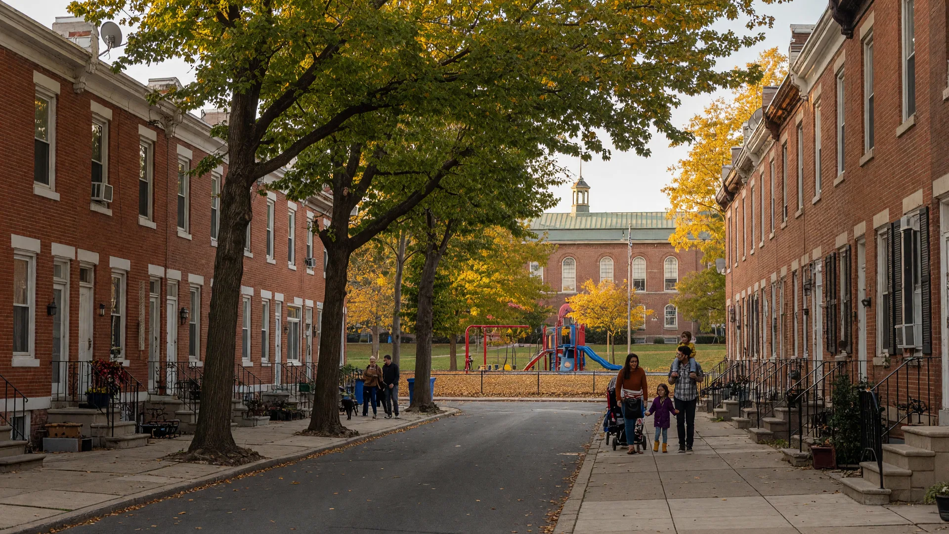Fairmount Philadelphia neighborhood with brick rowhomes, tree-lined streets, and families enjoying the park