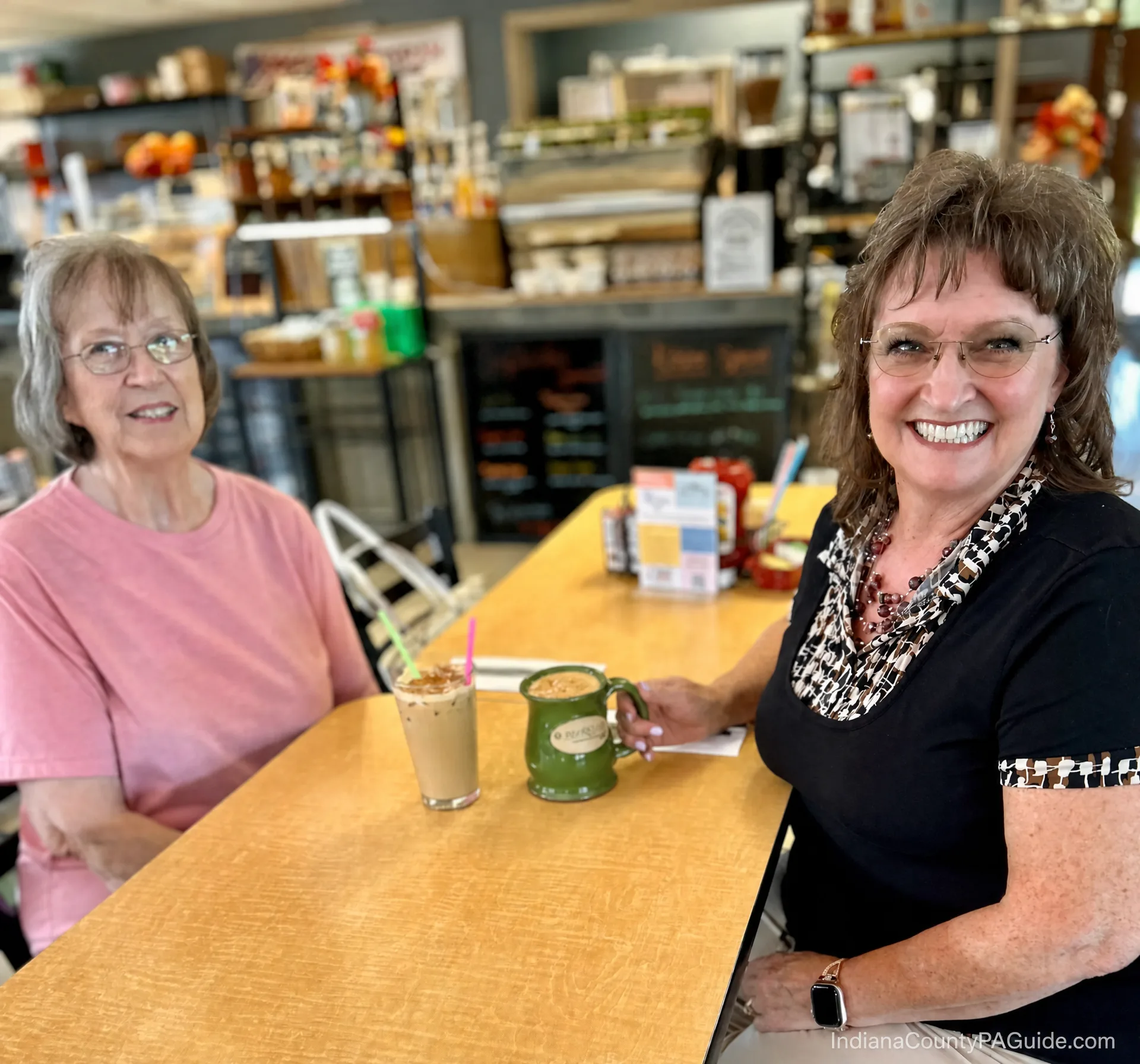 An iced coffee at Riziki Cafe inside the Jimmy Stewart Airport, with shelves stocked in the background