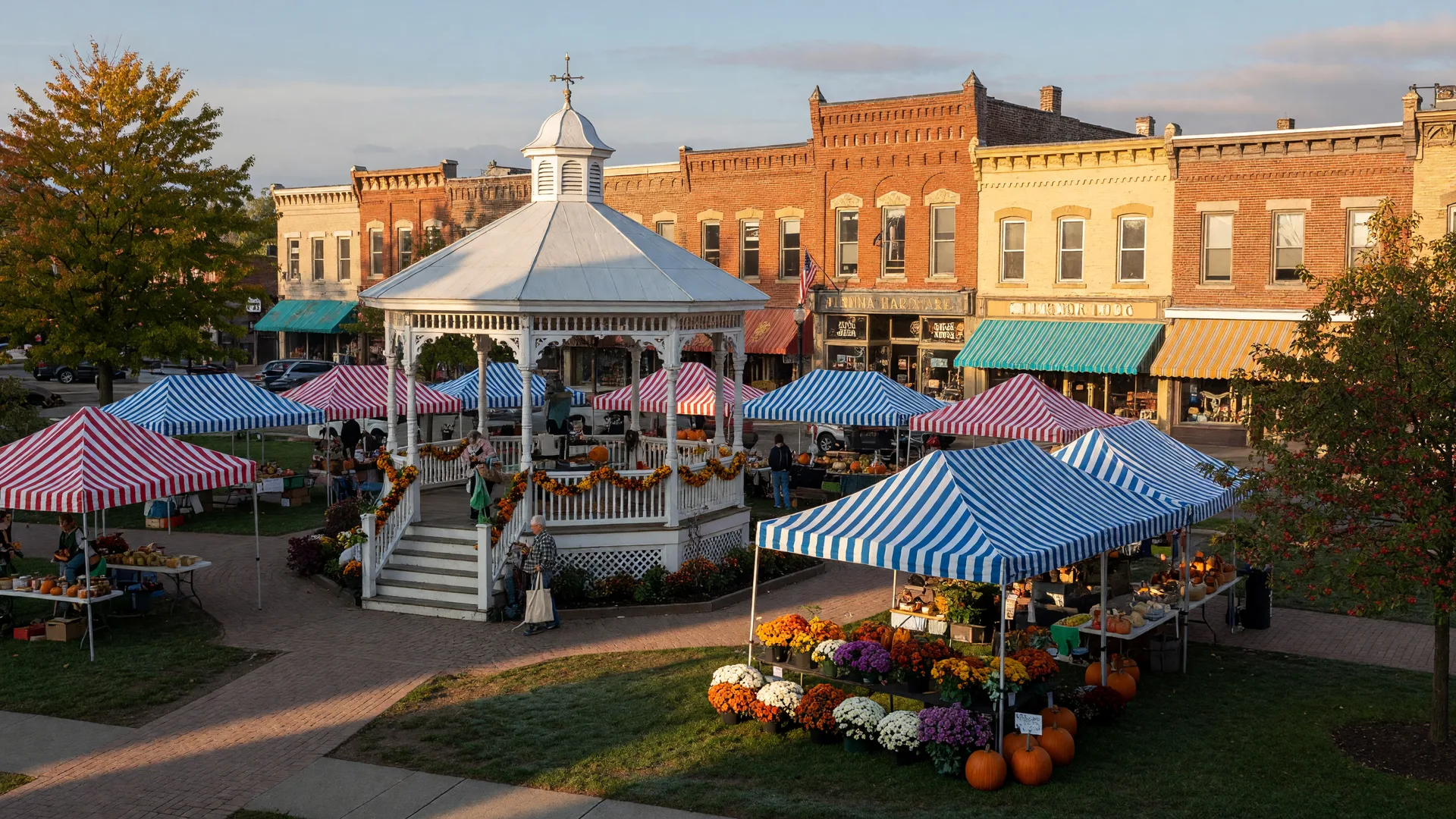 Medina's historic Public Square with white gazebo and farmers market stalls in golden September light
