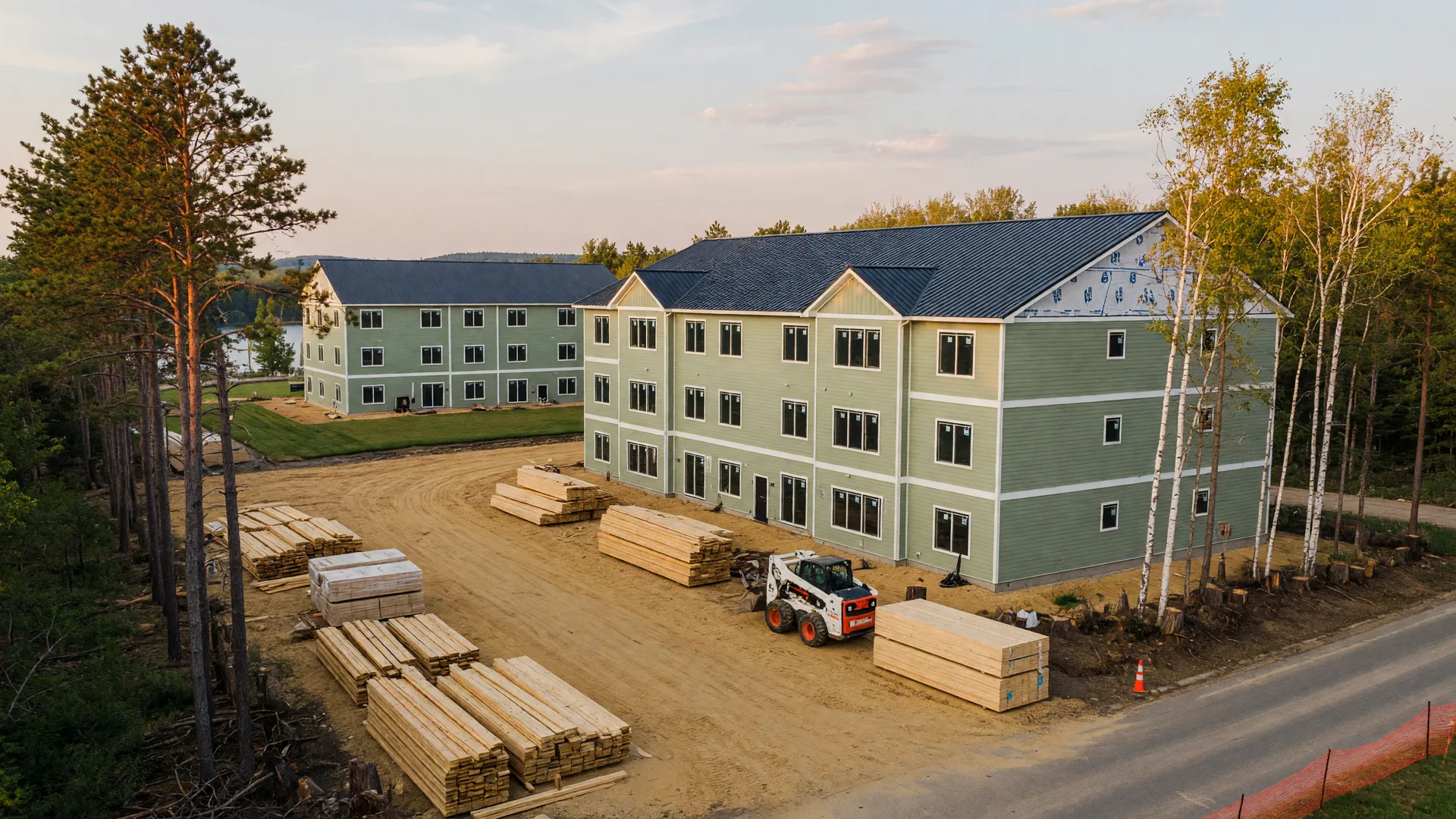 New apartment buildings under construction on a cleared lot in Brainerd, Minnesota, in late afternoon light