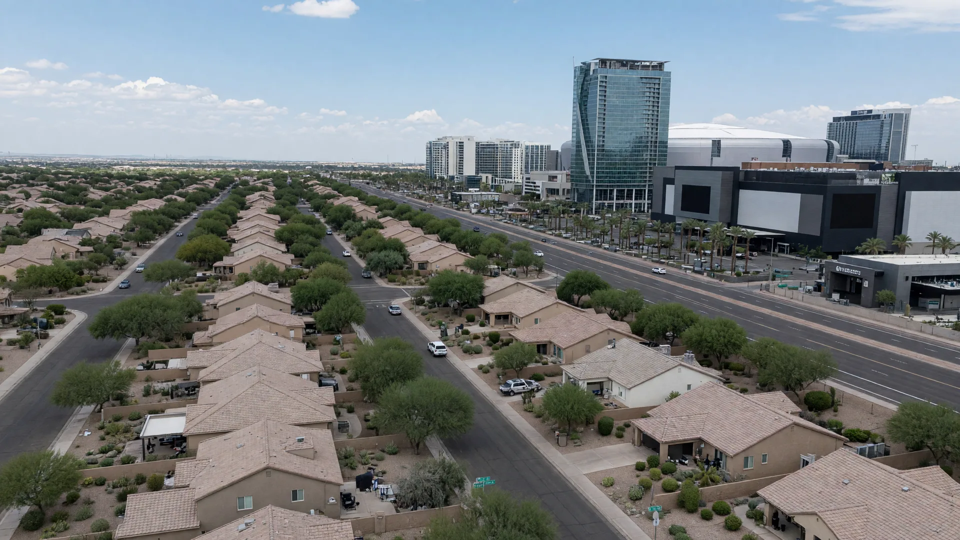 Golden hour aerial view of Glendale, Arizona, with State Farm Stadium and the Westgate Entertainment District glowing among palm-lined neighborhoods