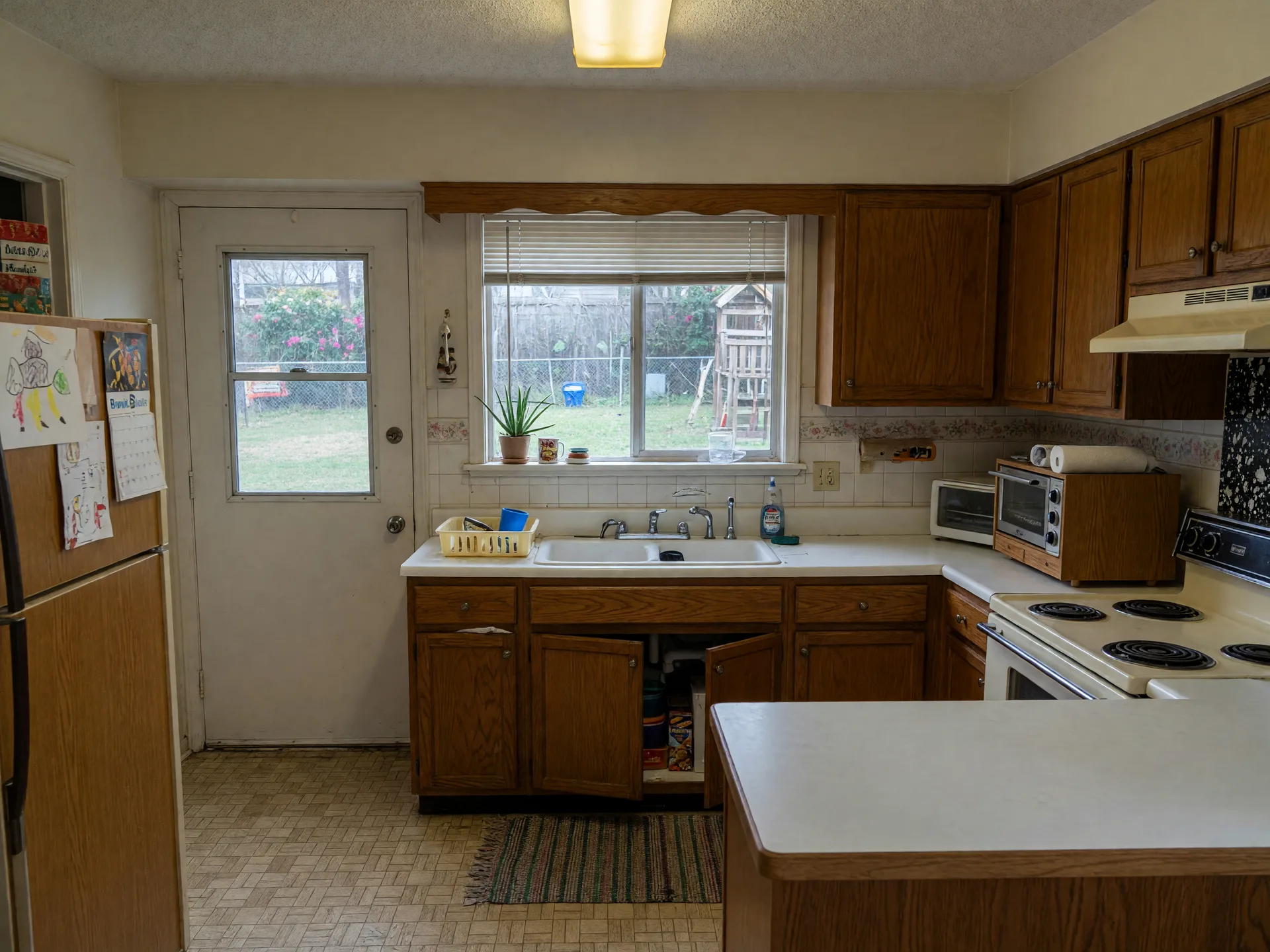 A kitchen undergoing light renovation in a Maryland colonial home with new white cabinets and quartz countertops being installed
