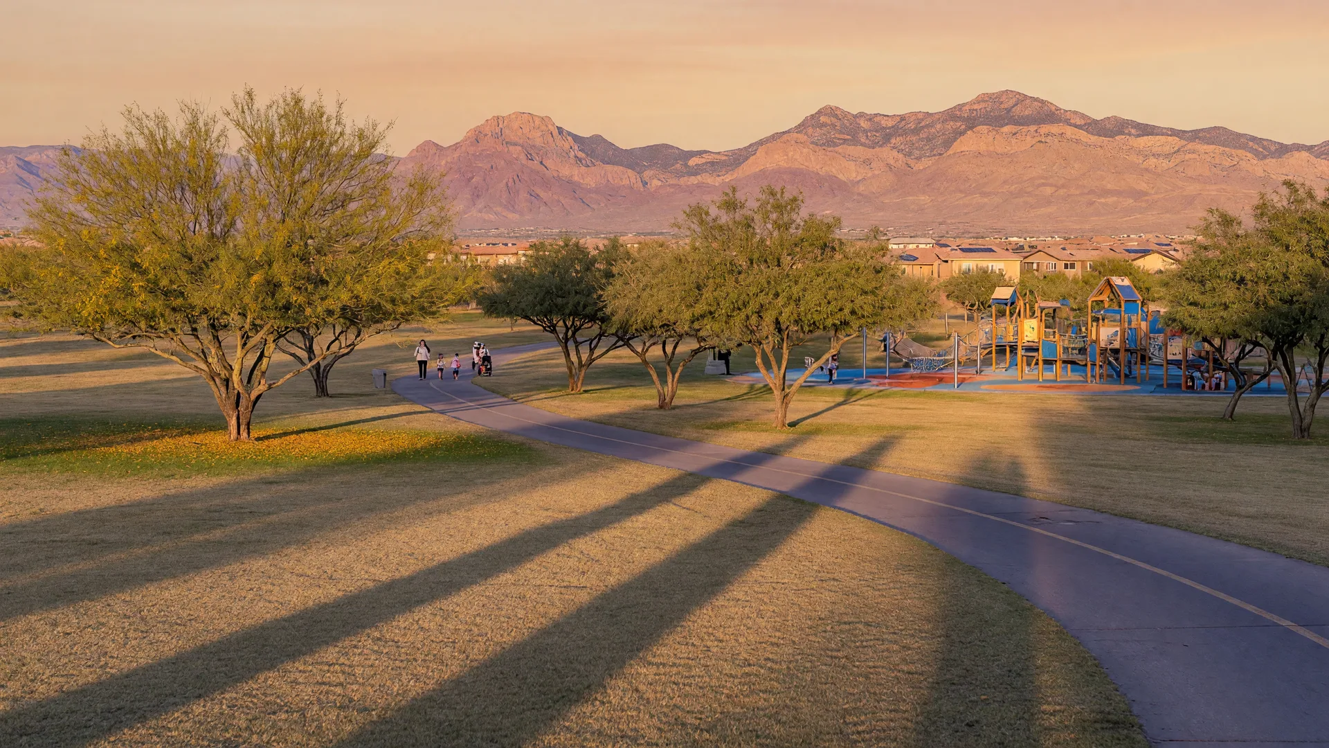 Family park in Mountain's Edge with playgrounds, walking trails, and mountain silhouettes