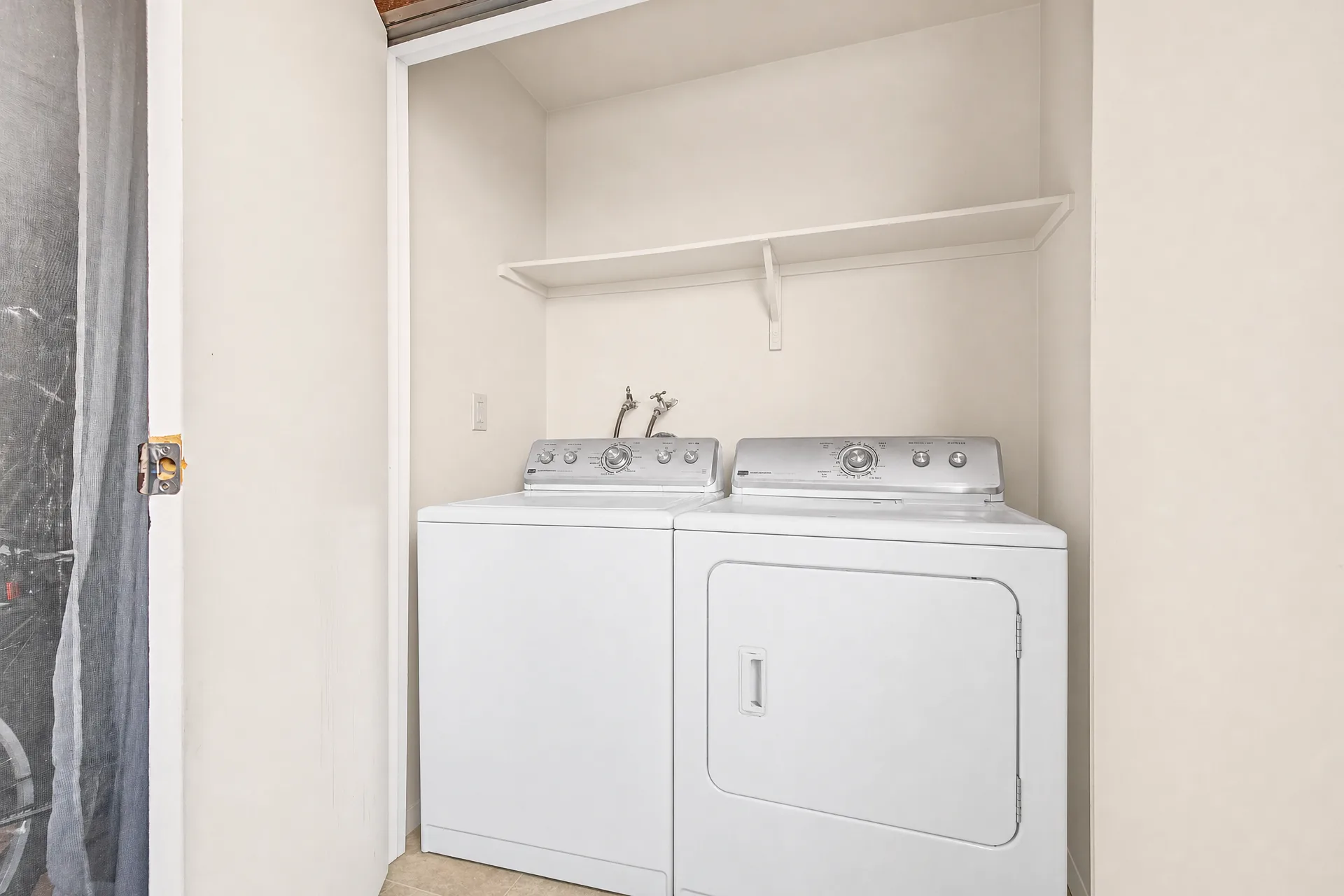 Virtually staged in-unit laundry closet with washer and dryer