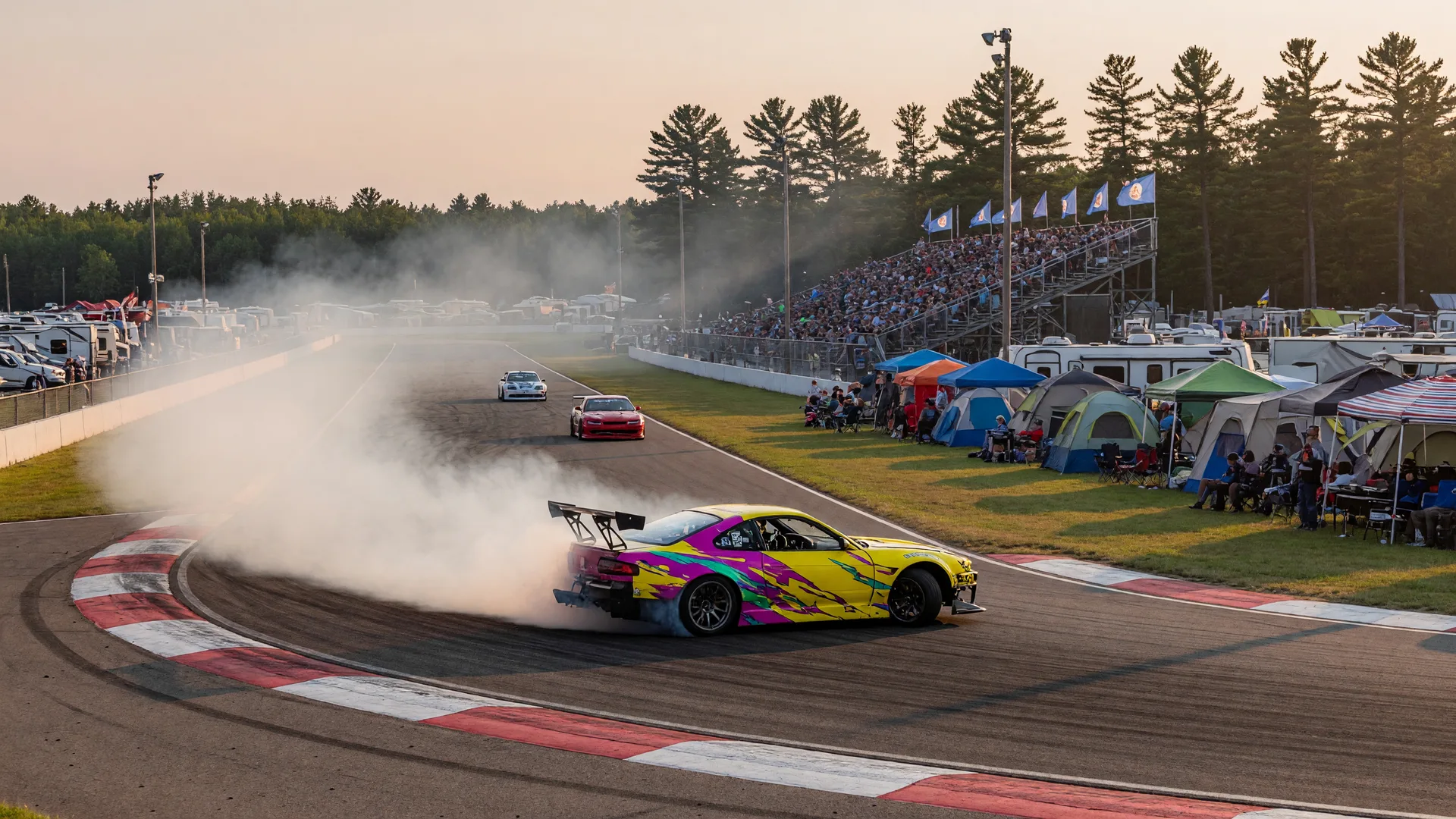 A drift car sliding through a road course corner with tire smoke at a motorsports festival in East Gull Lake, Minnesota