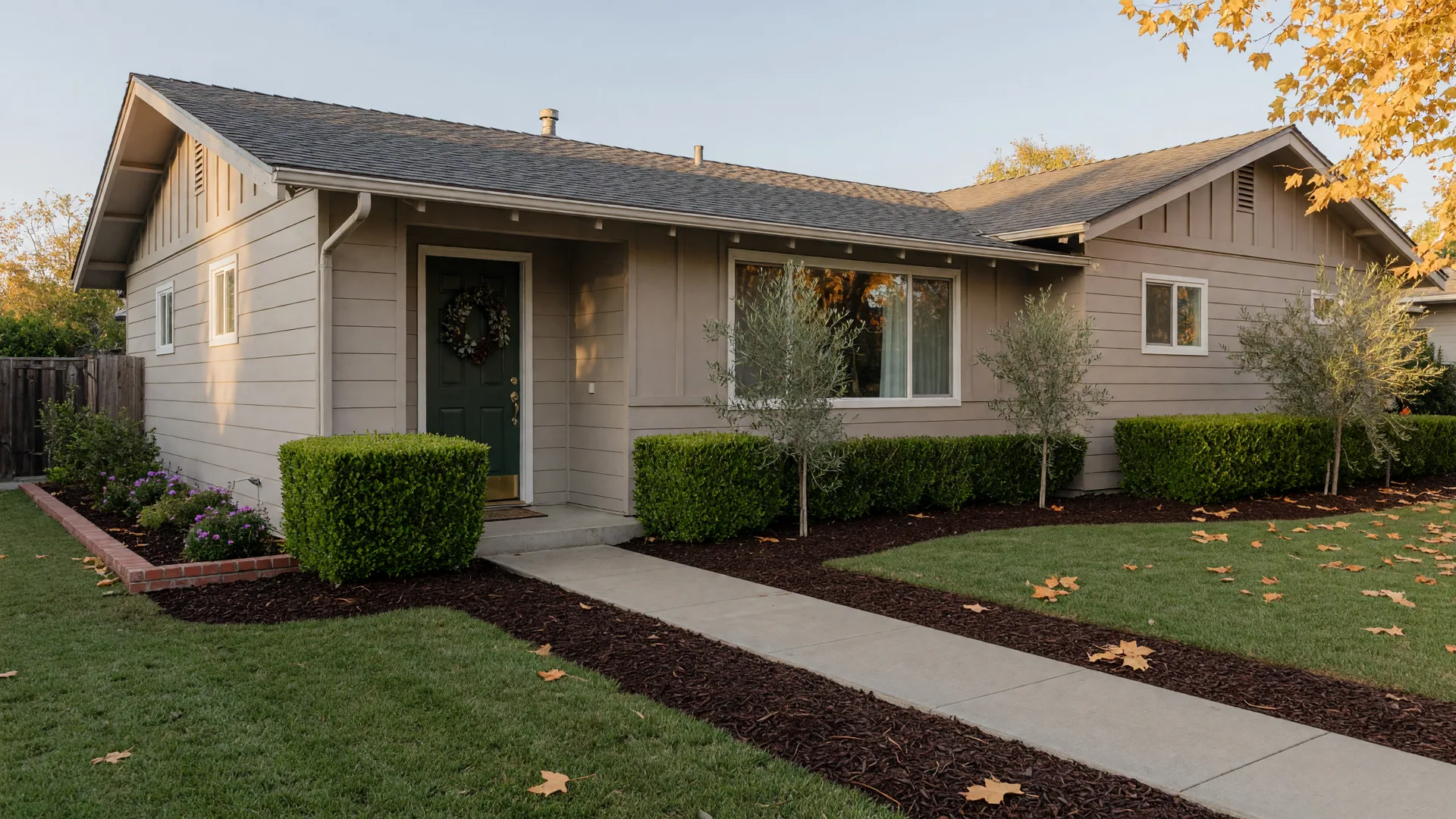 A freshly prepared ranch home on a clear autumn morning with crisp paint, edged landscaping, and a clean walkway