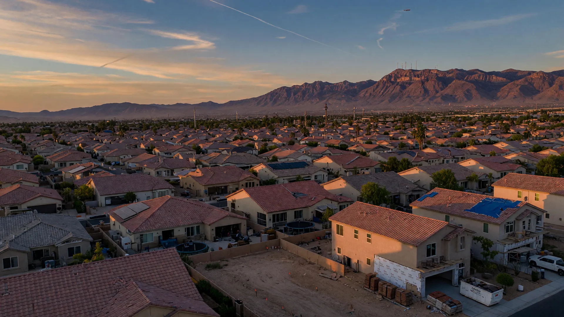 Aerial view of the Las Vegas Valley residential neighborhoods at golden hour with mountain backdrop