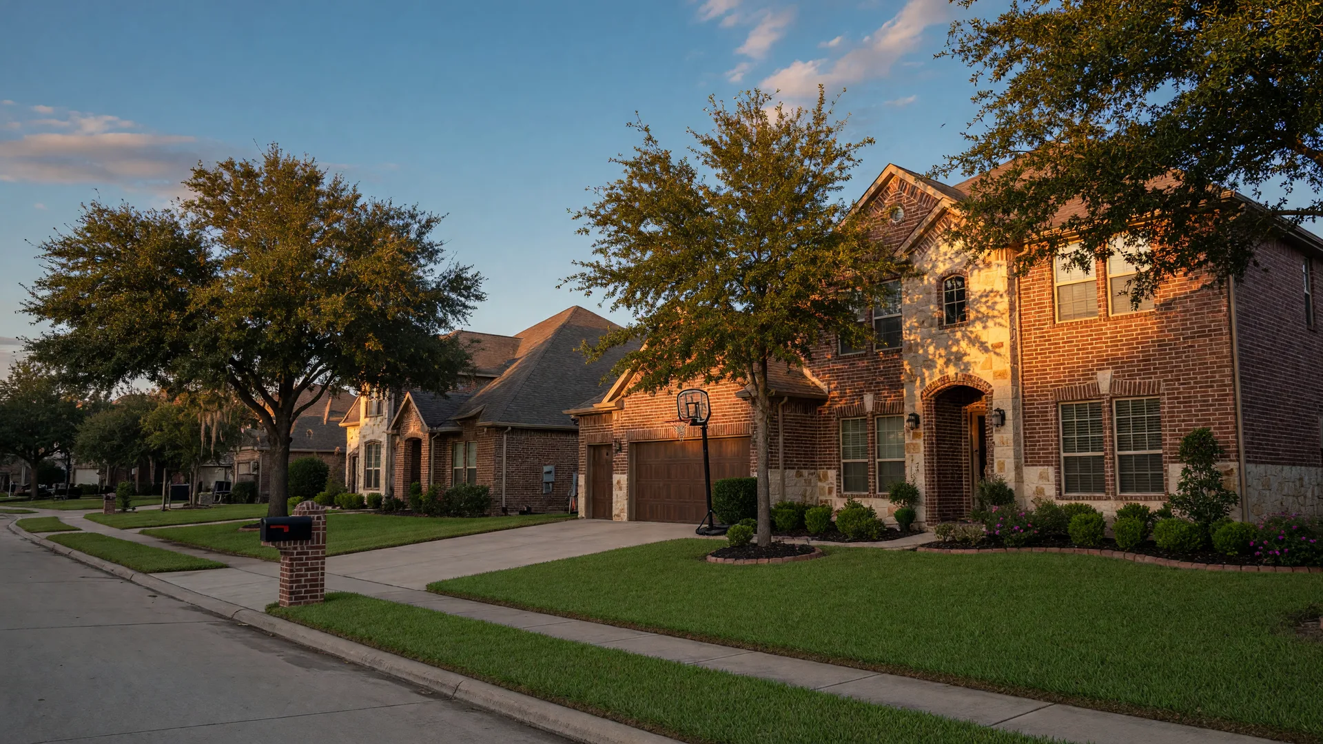 A brick home in a master-planned Katy community in late-afternoon light