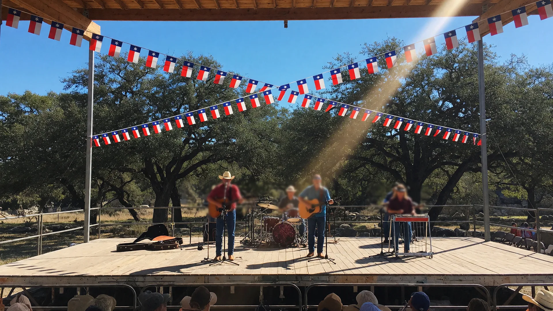 Live country band performing on the outdoor stage at Neon Armadillo in Wimberley
