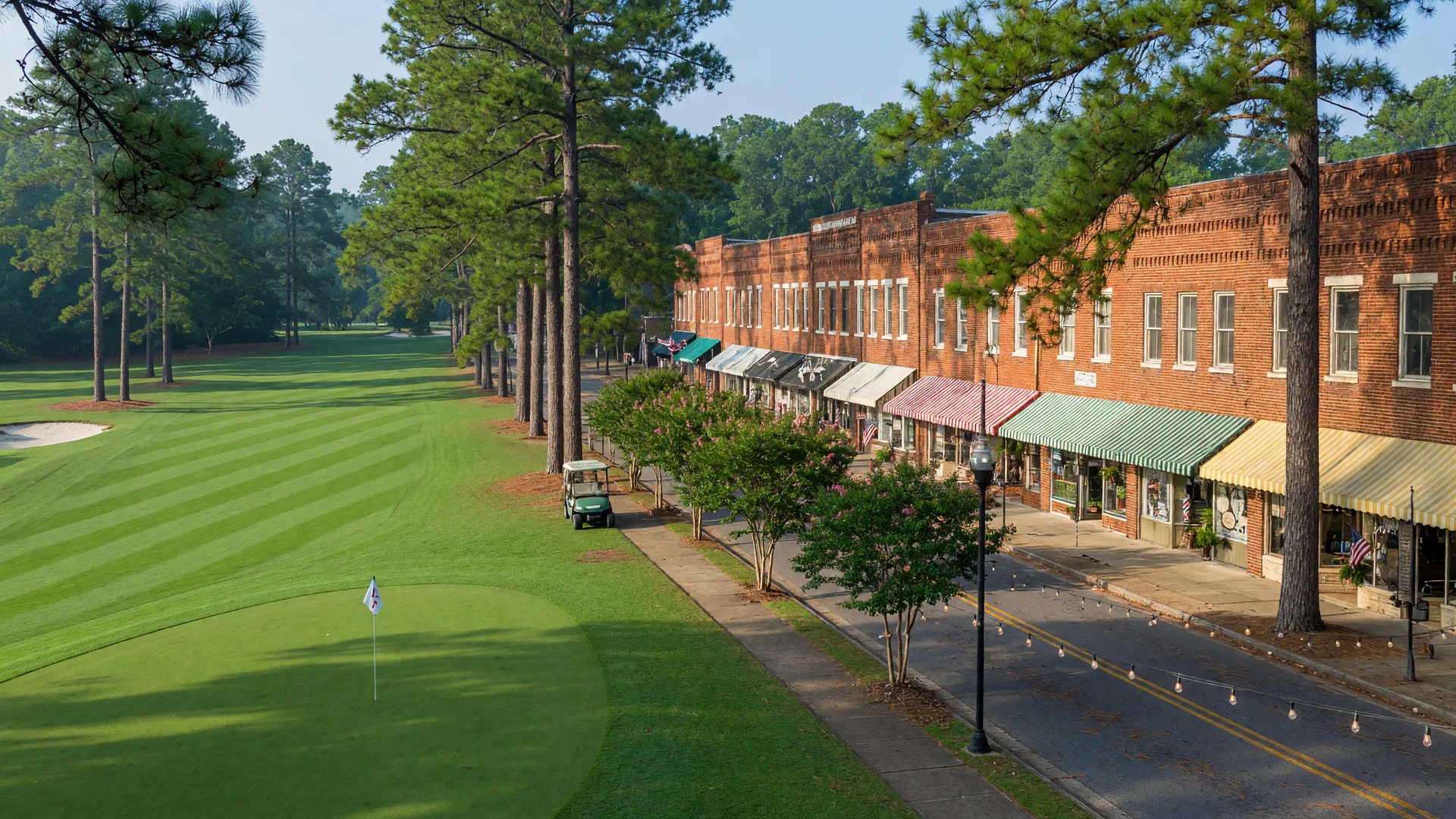 A Pinehurst golf fairway meeting the brick storefronts and string lights of a historic Sandhills downtown street
