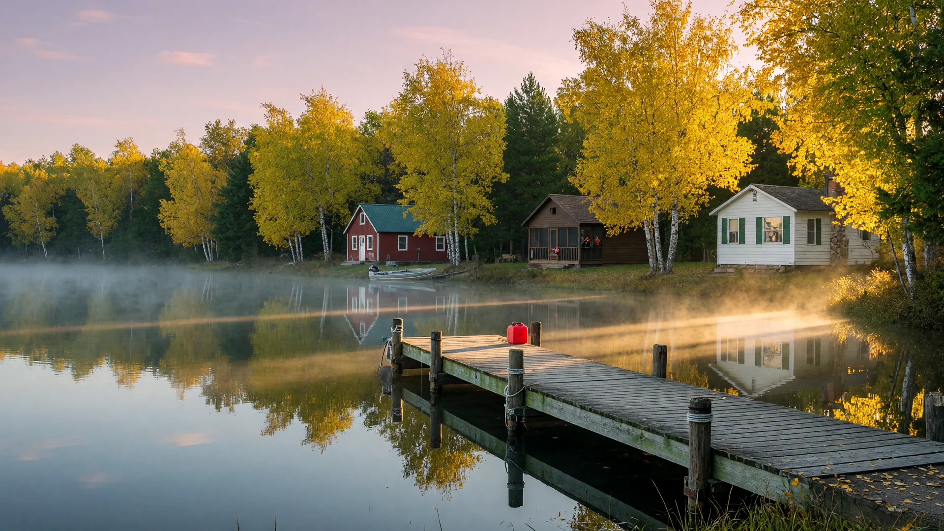 Early October golden fall color along a central Minnesota lake with cedar docks, lake cabins, and still water at first light
