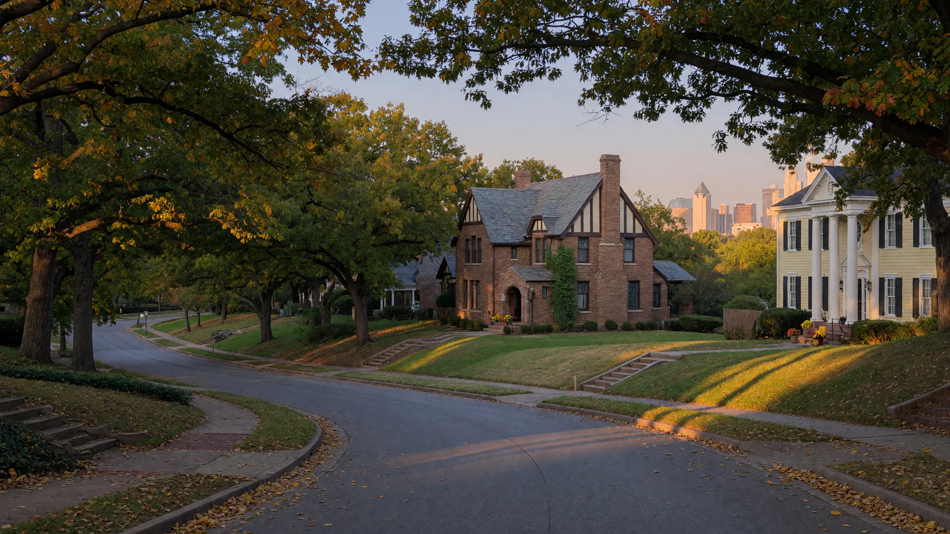 Historic revival-style homes on a winding, tree-lined street in the Kessler Park neighborhood of North Oak Cliff, Dallas