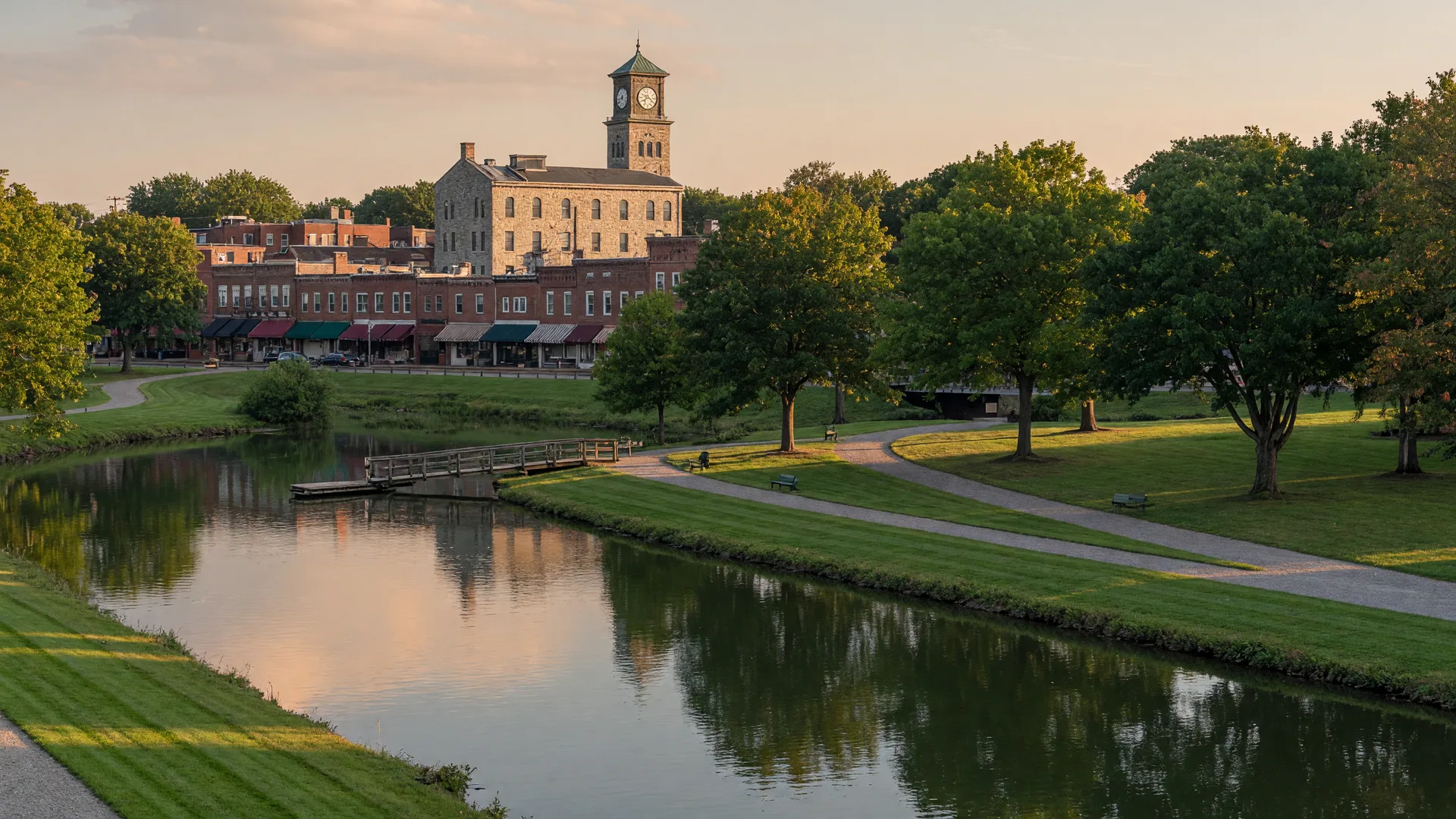 Rahway River and riverside park in the heart of Cranford NJ with downtown storefronts beyond the water