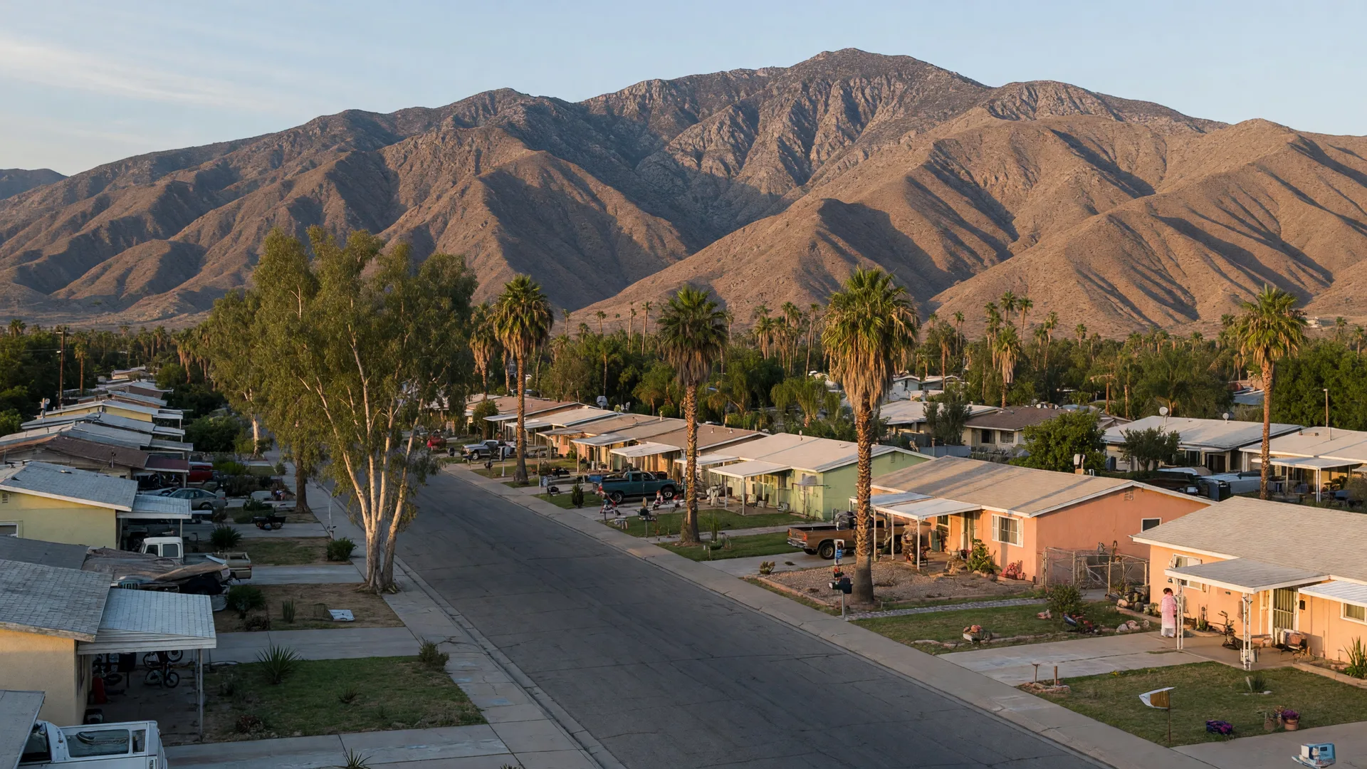 Quiet Hemet residential street with single-family homes and palm trees, the San Jacinto Mountains rising in the distance