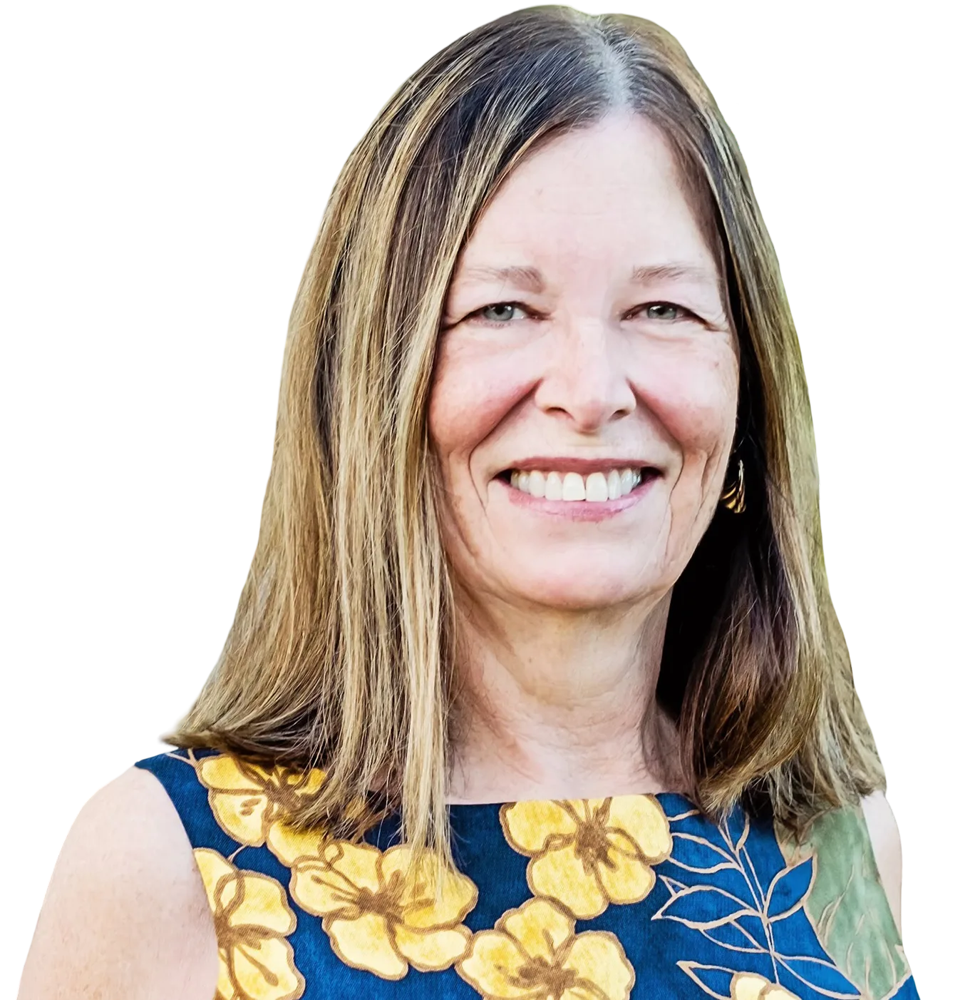 Carol Porter, Realtor® on Hawaiʻi Island, smiling in a blue and yellow floral top