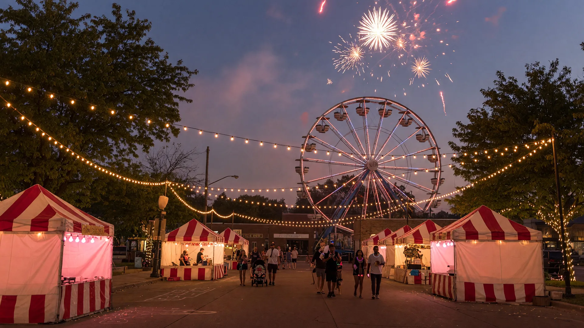 Labor Day weekend festival in a small Northwest Indiana town at dusk with carnival lights strung across main street, vendor tents, a Ferris wheel,and fireworks in the evening sky