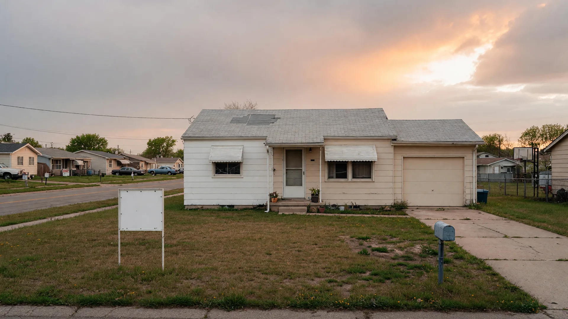 A modest HUD foreclosure home in a residential neighborhood with a patched roof and fresh paint
