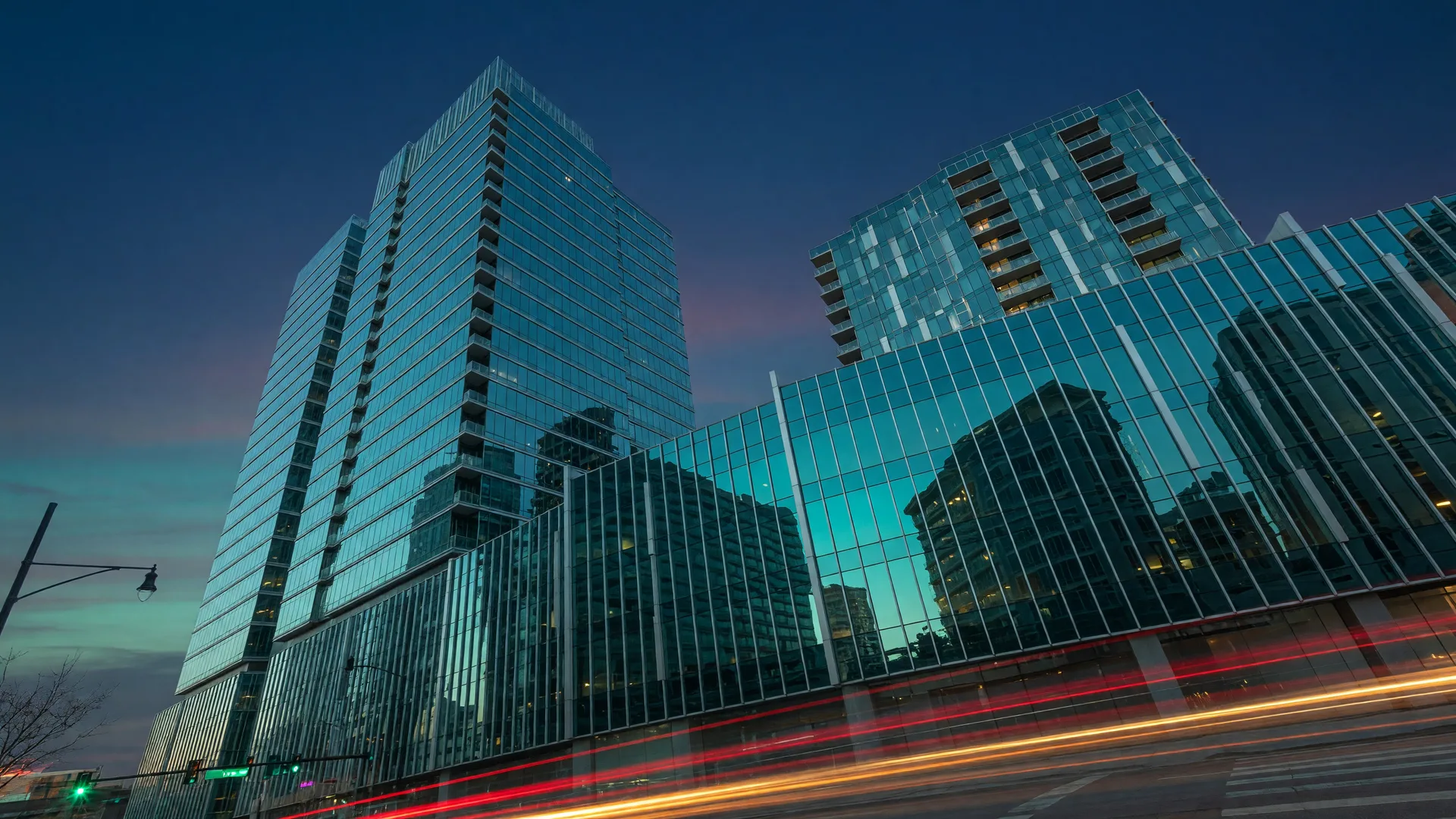 Modern glass high-rise buildings in downtown Dayton Ohio photographed from below at dusk, symbolizing growth and momentum