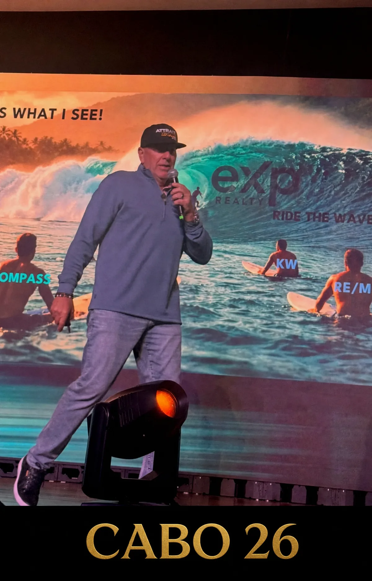 Coach Randy Byrd on stage with the gold CABO 26 backdrop