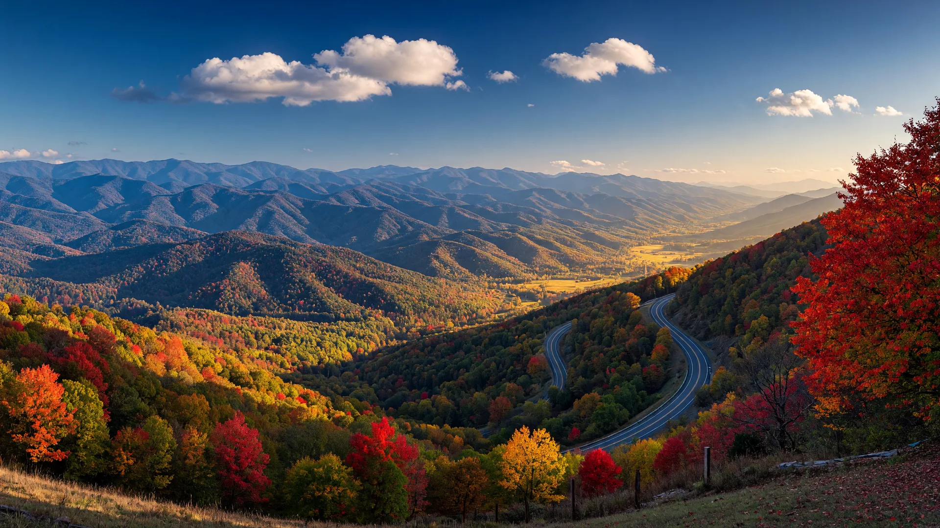 North Georgia mountains in peak autumn color seen from a scenic overlook with a winding mountain highway below