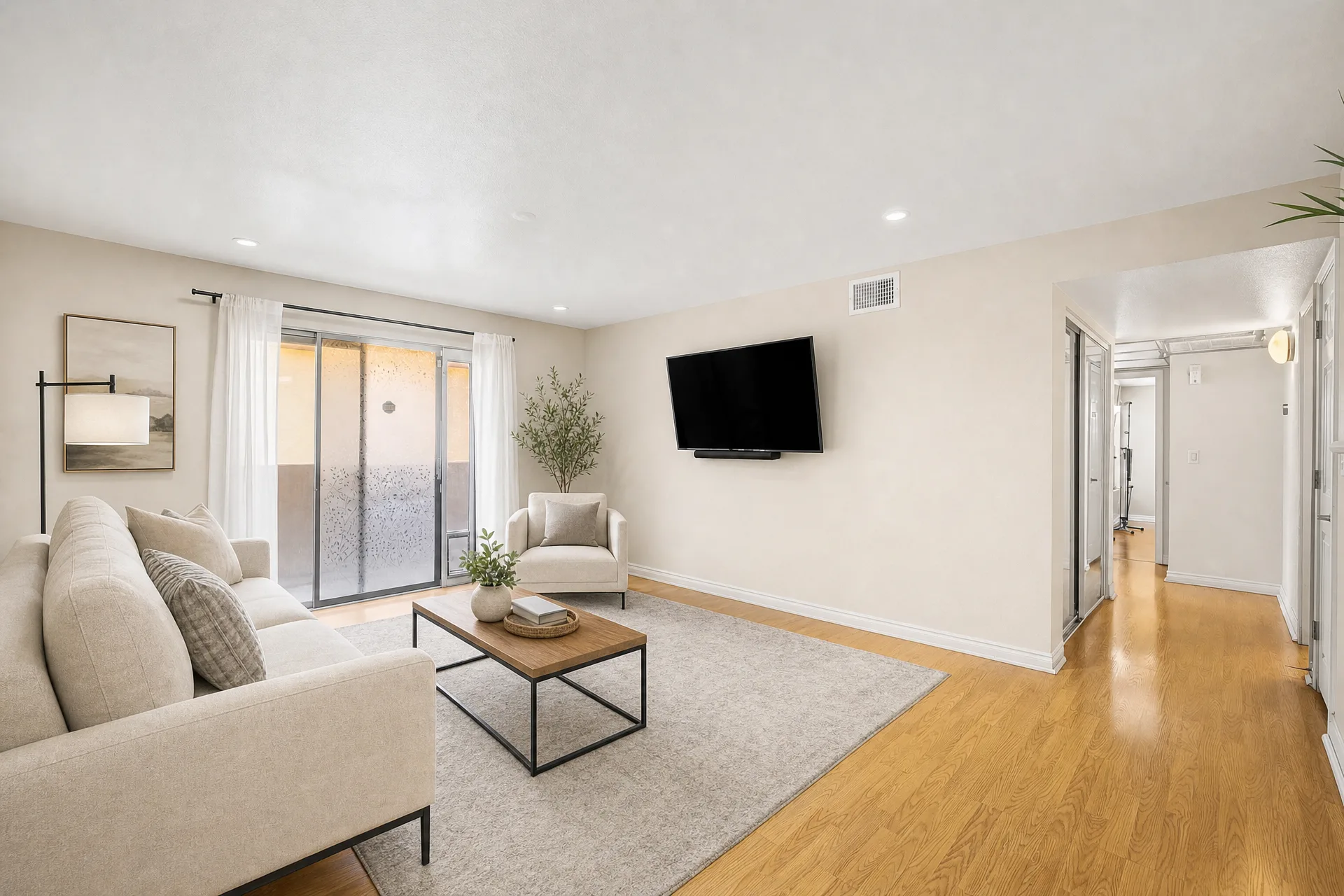 Virtually staged living room at 2451 Rainbow Blvd Unit 2122 with a wood-look plank accent wall